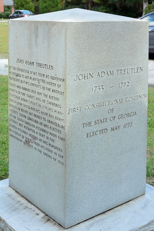 White granite monument inscribed with the name John Adam Treutlen